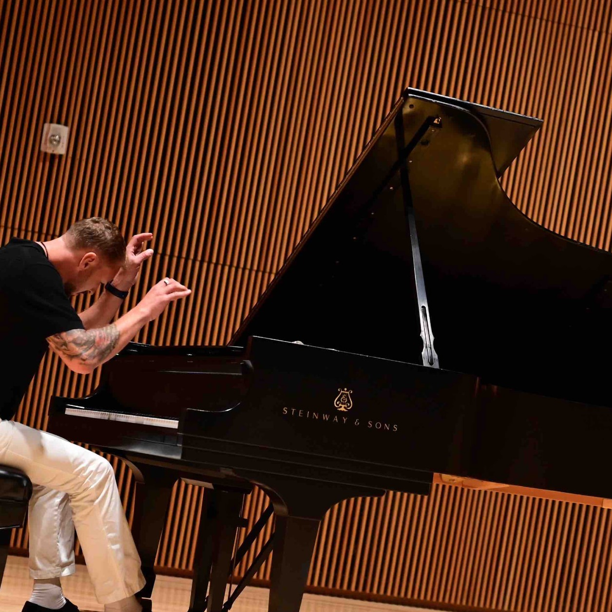 Vlad Krik performing at the grand piano on stage, New York 2022
